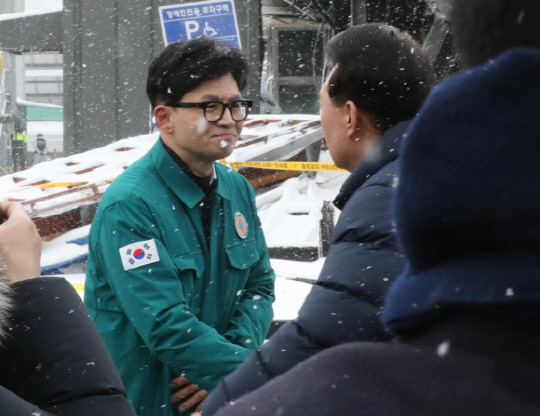 윤석열 대통령이 지난 23일 충청남도 서천군 서천읍 서천특화시장 화재 현장에서 한동훈 국민의힘 비상대책위원장과 만나 인사하고 있다. <연합뉴스>